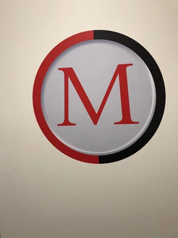 One of ManTechs logos as a wall graphic, to tie in all of the black and red themed signage and walls in the building.