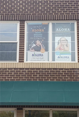 This perforated vinyl for Aloha Mind was installed on the exterior of the second floor window.